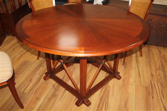 A 20th century French cherrywood radially extending dining table, the circular table extends to 6ft 7in.